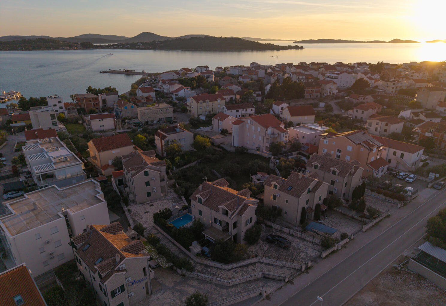 Aerial view of the villa, highlighting its coastal position.