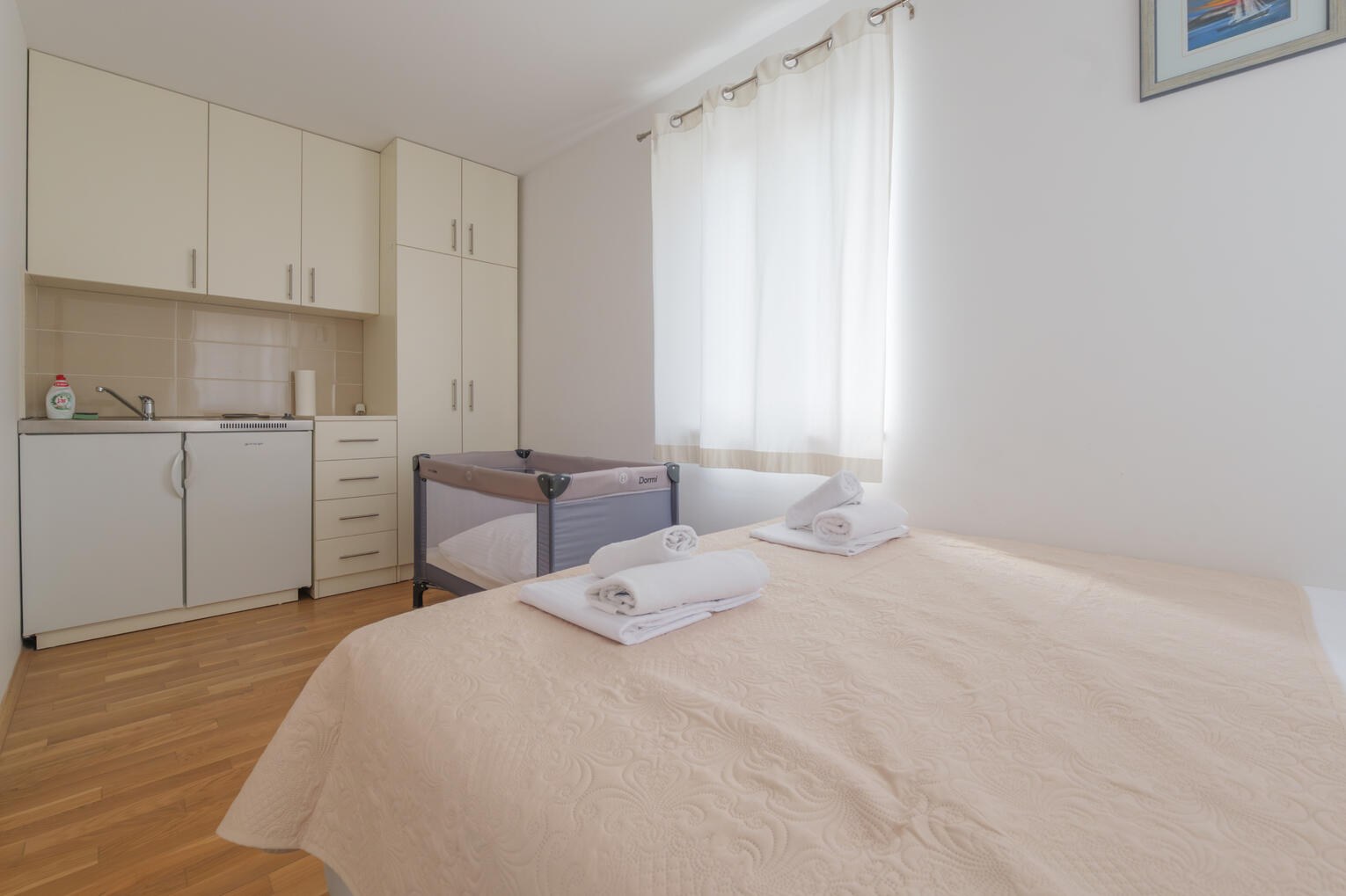 Bedroom with cot and kitchenette