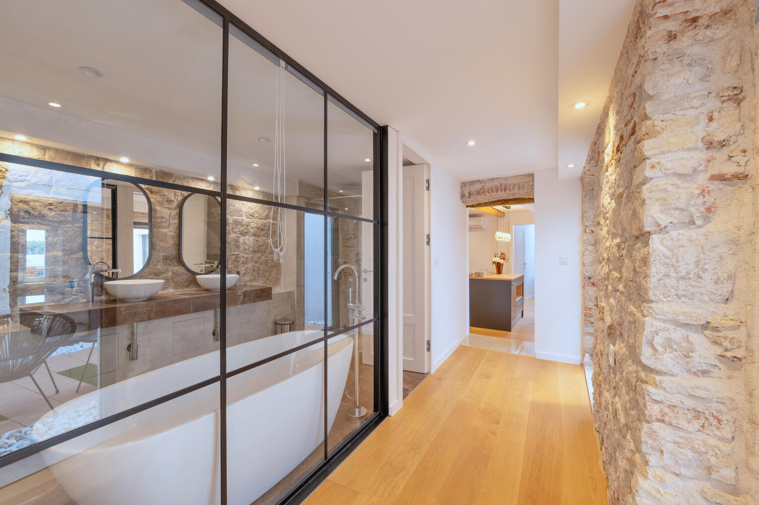 Hallway towards kitchen with view of the bathroom